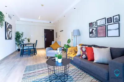 a living room with a couch and a table at 2BR Breathtaking Waterfront Heart of Marina in Dubai