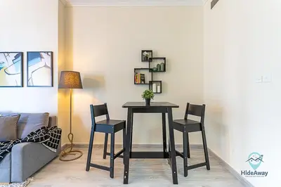 a table and two chairs in a living room at 1BR Modern, Stylish l Mins to Beach l Dubai Marina in Dubai