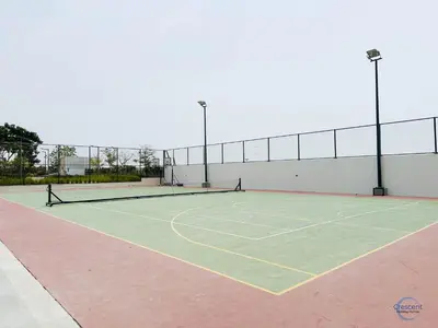 a tennis court with two tennis rackets on it at Luxurious Studio in Damac Hills in Dubai