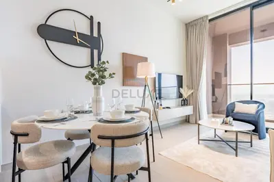 a white dining room with a table and chairs at Skyline-View 1BR with Balcony,Minutes to Downtown and Marina, Binghatti Onyx, Jumeirah Village Circle by Deluxe Holiday Homes in Dubai