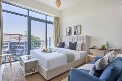 a bedroom with a king sized bed and a couch at Frank Porter - Azizi Riviera 16 in Dubai