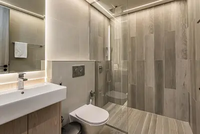 a bathroom with a sink and a toilet and a shower at Elegant 1BDR apartment in JVC in Dubai