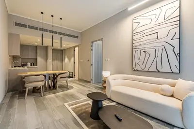 a living room with a couch and a table at Elegant 1BDR apartment in JVC in Dubai