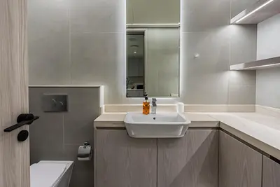 a bathroom with a sink and a mirror at Elegant 1BDR apartment in JVC in Dubai