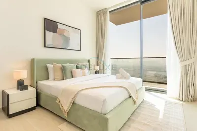 a bedroom with a large bed and a large window at High-Rise 1BR with Lake and City Views Easy Access to Downtown and Marina, Binghatti Onyx, Jumeirah Village Circle by Deluxe Holiday Homes in Dubai