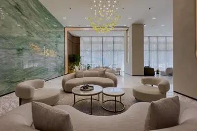 a living room with couches and chairs and a chandelier at High-Rise 1BR with Lake and City Views Easy Access to Downtown and Marina, Binghatti Onyx, Jumeirah Village Circle by Deluxe Holiday Homes in Dubai