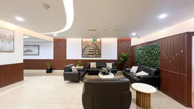 a lobby with couches and chairs in a building at 1BR Beach House Vibes in Prime Marina Location in Dubai