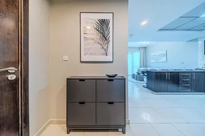 a room with a cabinet and a picture on the wall at 1 BD in Bay Central with the Iconic Marina Views in Dubai