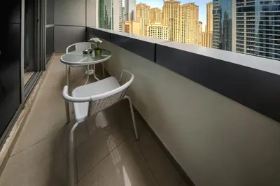 a balcony with a table and a view of the city at 1 BD in Bay Central with the Iconic Marina Views in Dubai