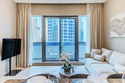 a living room with a couch and a large window at 1 BD in Bay Central with the Iconic Marina Views in Dubai