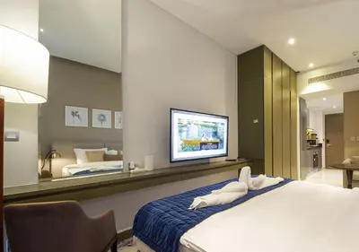 a bedroom with a bed and a large mirror at Luxury Damac Studio w Canal View Near Burj Khalifa in Dubai