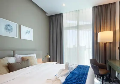 a hotel room with a bed and a window at Luxury Damac Studio w Canal View Near Burj Khalifa in Dubai