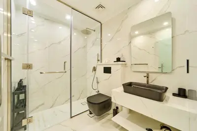a bathroom with a sink and a shower at Luxury 1BR in Zaafran With Stunning Burj Khalifa View in Dubai