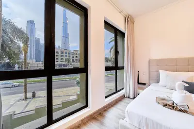 a bedroom with a bed and a window with a view of a street at Luxury 1BR in Zaafran With Stunning Burj Khalifa View in Dubai