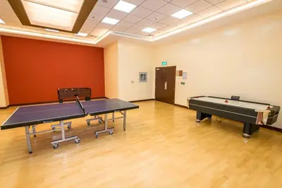 a large room with two ping pong tables in it at 1BR Tropical Vibes Near Skydiving and Beach! in Dubai
