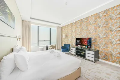 a hotel room with a bed and a television at Exquisite studio - Highest at the Palm Tower in Dubai