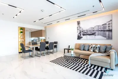 a living room with a couch and a table at Bright Modern 1BR Heart Of JLT Skyline Views in Dubai