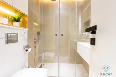 a bathroom with a glass shower with a toilet at Bright Modern 1BR Heart Of JLT Skyline Views in Dubai