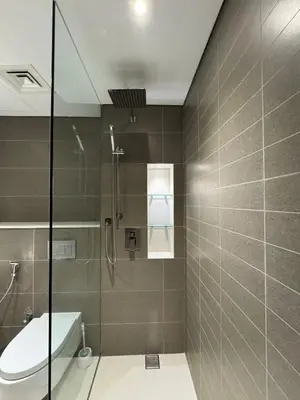 a bathroom with a shower with a toilet and a sink at New luxury Studio at Prestigious Liv Residence in Dubai