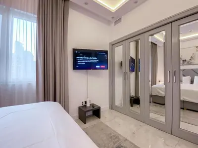 a bedroom with a bed and a tv on the wall at Live the Burj Lifestyle in Timeless OldTown by SBH in Dubai