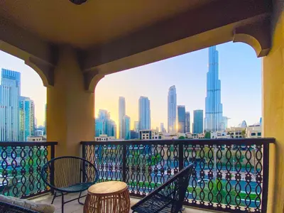 a balcony with chairs and a view of the city at Live the Burj Lifestyle in Timeless OldTown by SBH in Dubai