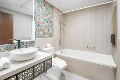 a bathroom with a tub and a toilet and a sink at Arabian Nights 1BR - Burj Khalifa & Fountain Views - 5 Mints Walk to Burj Khalifa and Dubai Mall in Dubai
