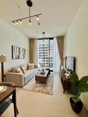 a living room with a couch and a table at Tranquil 1br Retreat Stylish Stay In Jvc in Dubai