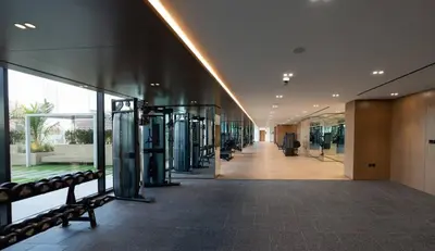 a hallway of a building with a gym at Tranquil 1br Retreat Stylish Stay In Jvc in Dubai
