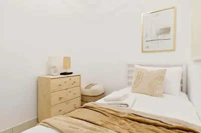 a bedroom with a bed and a wooden dresser at Silkhaus Luxe 2 BDR with Maid room in Springs 7 Villa 14 in Dubai