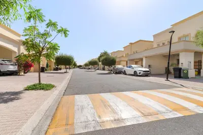 a street with cars parked on the side of the road at Silkhaus Luxe 2 BDR with Maid room in Springs 7 Villa 14 in Dubai