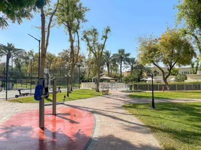 a park with a parking meter on a sidewalk at Silkhaus Luxe 2 BDR with Maid room in Springs 7 Villa 14 in Dubai