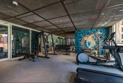 a gym with tread machines and a wall with a mural at Wonderful Stay at Collective 2- Unique in Dubai Hills - 5 min to Dubai Hills Mall - Brand New Luxury Apartments in Dubai