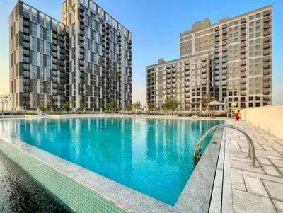 a large swimming pool with two tall buildings at Wonderful Stay at Collective 2- Unique in Dubai Hills - 5 min to Dubai Hills Mall - Brand New Luxury Apartments in Dubai