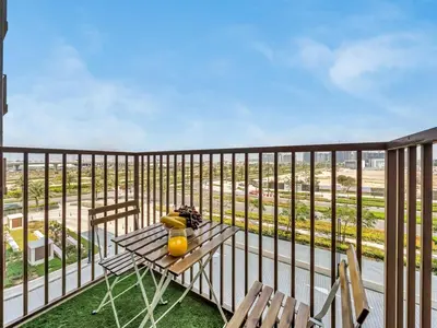 a balcony with a table and chairs on a balcony at Wonderful Stay at Collective 2- Unique in Dubai Hills - 5 min to Dubai Hills Mall - Brand New Luxury Apartments in Dubai