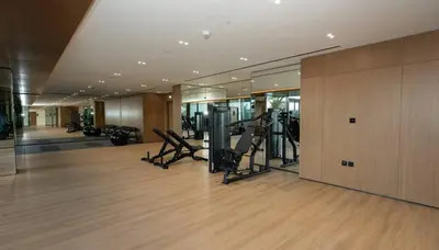 a gym with treadmills and exercise equipment in a building at Modern 1br W Calm Interiors Jvc Dubai in Dubai
