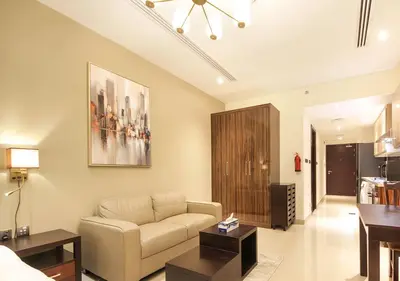 a living room with a couch and a table at Elite Downtown Stay with Gym, Pool near Dubai Mall in Dubai