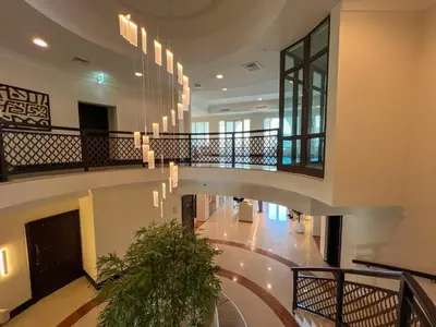 a large lobby with a staircase with chandeliers at Durrani Homes - Luxe Living at Souk Al Bahar with Burj Khalifa and partial Fountain view in Dubai