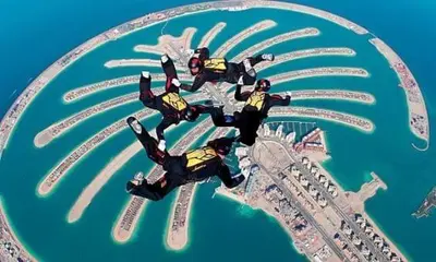 a group of people in suits on top of a city at 1BR Cool Vibes Pool Views Dubai Marina in Dubai