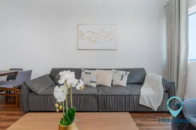a living room with a couch and a table at 1BR Cozy and Bright Dubai Marina in Dubai