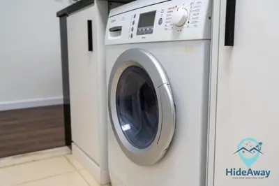 a white washing machine in a laundry room at 1BR Cozy and Bright Dubai Marina in Dubai