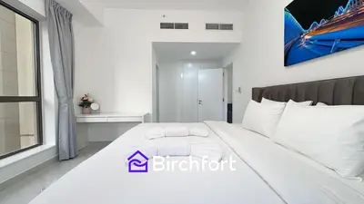a bedroom with a large white bed in a room at Spacious and Bright Retreat in JBR in Dubai
