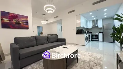 a living room with a couch and a kitchen at Spacious and Bright Retreat in JBR in Dubai