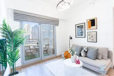 a living room with a couch and a table at 1BR Marina View Rooftop Pool Dubai Marina in Dubai