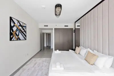 a living room with a large white couch at VayK - Luxury 1BR in Downtown in Dubai