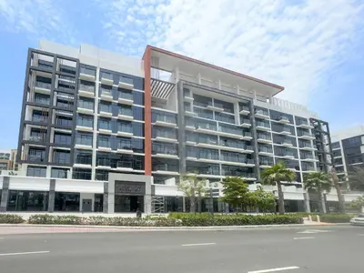 a large apartment building on the side of a street at VayK - Modern 3BR with a Spacious Terrace in Dubai