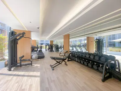 a gym with a bunch of equipment in a room at VayK - Stylish & Cozy Studio in JVC in Dubai