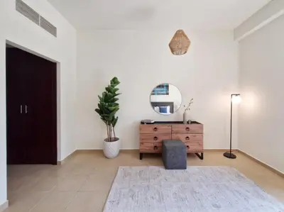 a living room with a dresser and a mirror at Enchanting Stay in JBR Near The Beach in Dubai