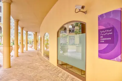 a hallway of a building with columns and a window at Enchanting Stay in JBR Near The Beach in Dubai