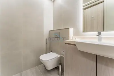 a bathroom with a white toilet and a sink at City Views 1BR with Balcony Near Mall, Concept 7 Residences, Jumeirah Village Circle by Deluxe Holiday Homes in Dubai