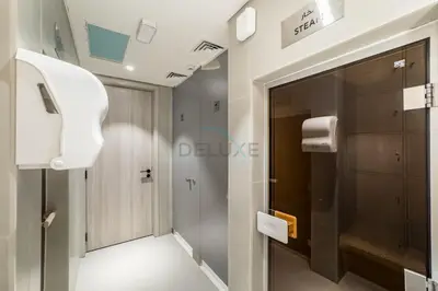 a bathroom with a glass door and a toilet at City Views 1BR with Balcony Near Mall, Concept 7 Residences, Jumeirah Village Circle by Deluxe Holiday Homes in Dubai